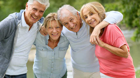 Four elderly people standing together