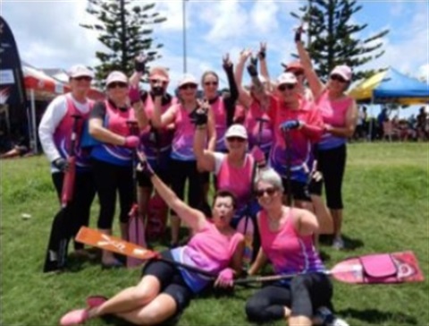 Group of women smiling for the photo from dragon boat races