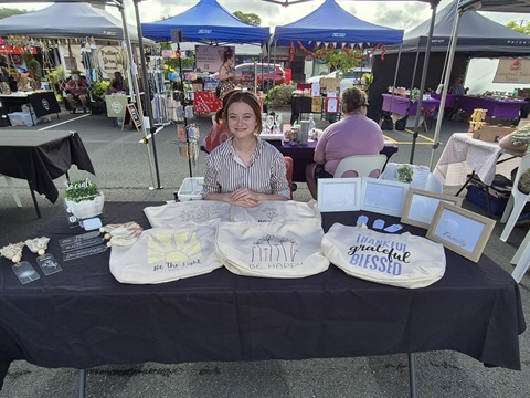 Person at their market stall selling items