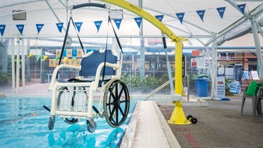 Enclosed heated program swimming pool hoist