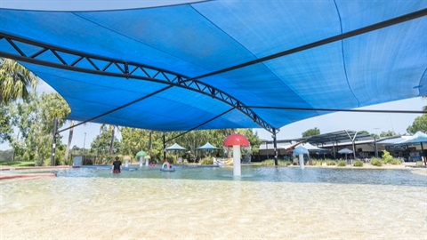 The shaded leisure pool with relaxing water features and a beach sloped entry