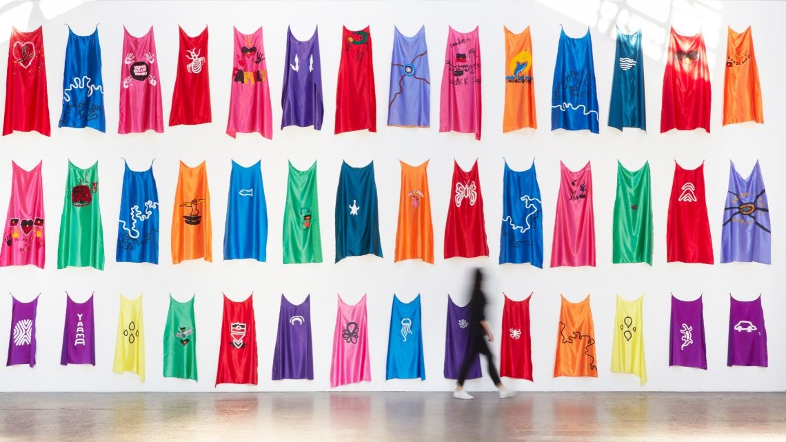 Art installation of rows of coloured capes