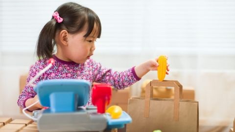 Girl with black hair playing shops