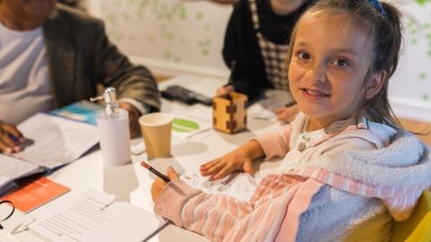 A girl crafting at a table