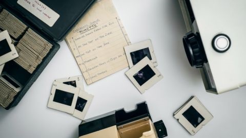 Old photo slides scattered on a table