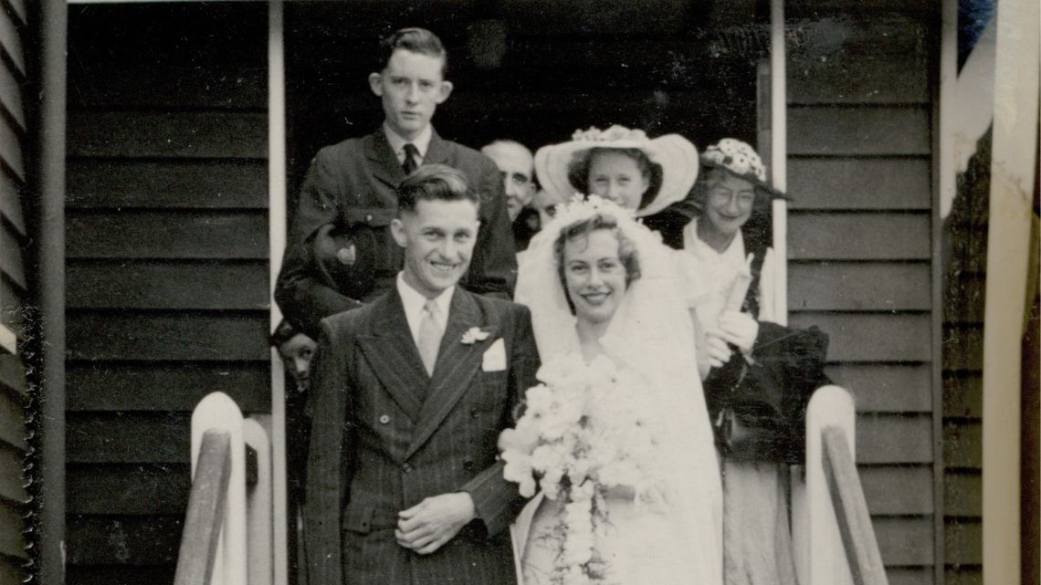 Black and white photo of a bridal couple on the steps of a building