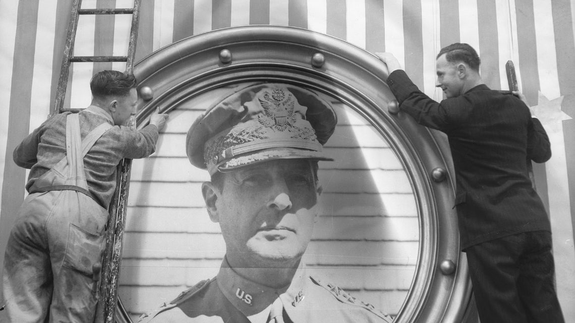 Myer staff hanging a portrait of General Douglas MacArthur