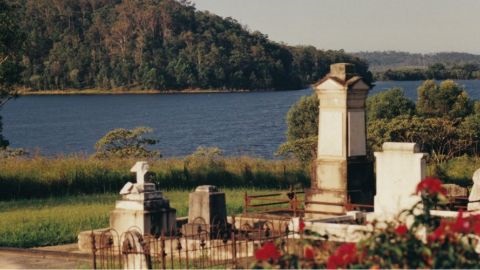 Cemetery headstones with lake in background