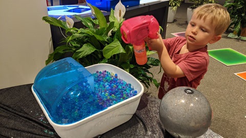 Little boy playing with gel balls