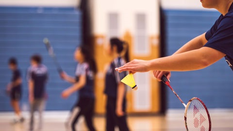 person playing badminton - image focuses on the racquet