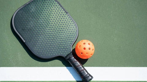 paddle racket and ball on the ground