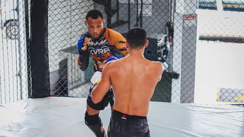 Two people fighting in cage