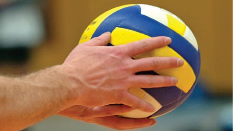 hands holding a volleyball