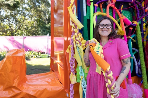 Shan Michaels at Pridefest surrounded by her artwork.