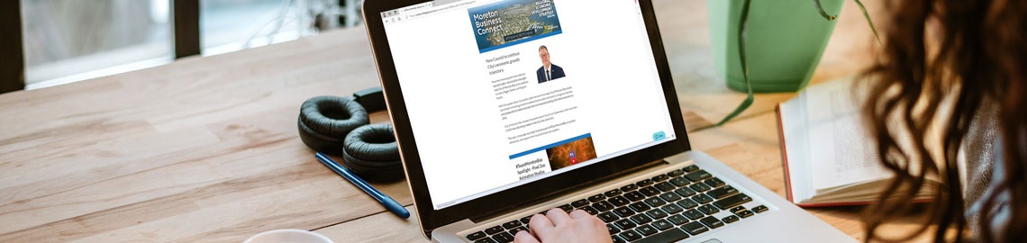 women looking at laptop reading the business connect newsletter