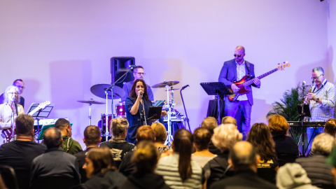 Blue Turtles on stage performing to a standing crowd.