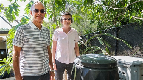 Warren and Penny Mack standing with their compost bins