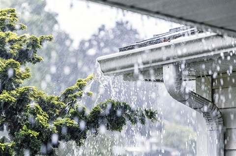 Overflowing gutters in heavy rain